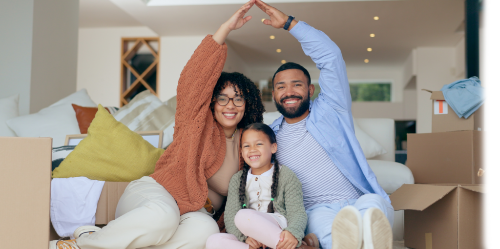 smiling family moving into their first home with their child