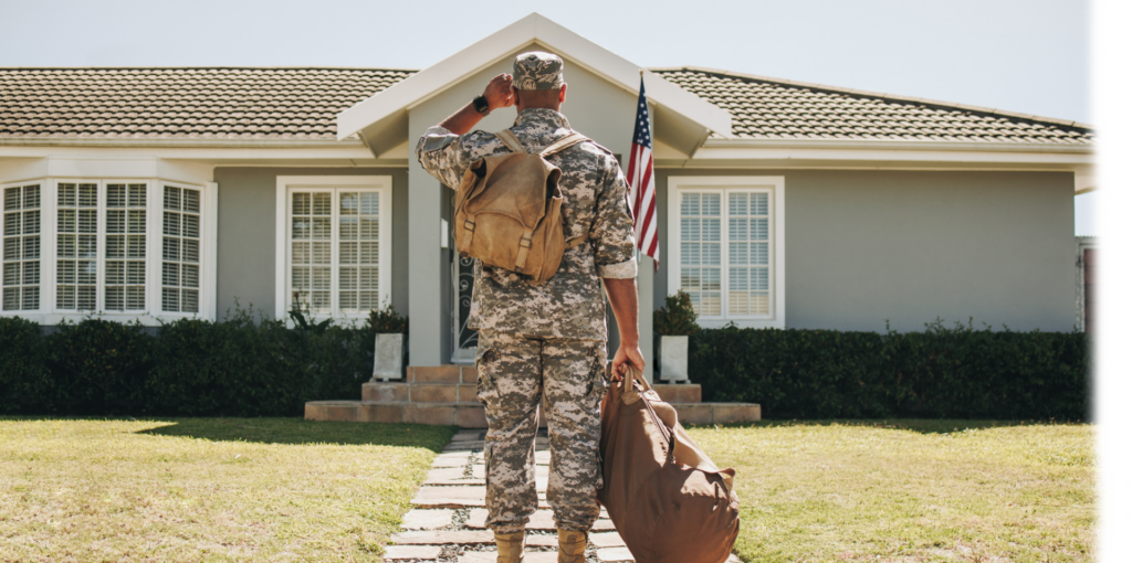 Man in uniform standing outside of home.