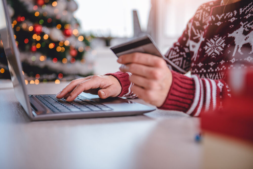 Woman shopping online with card for Chirstmas gifts